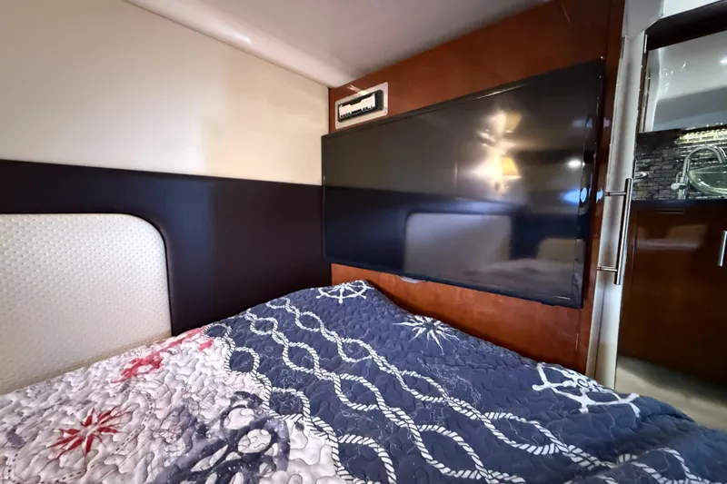  Yacht Photos Pics Interior of 2015 Regal 46 Sport Coupe with bed and mounted TV.