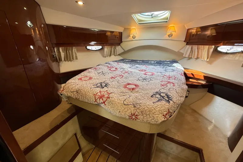  Yacht Photos Pics Luxurious 2015 Regal 46 Sport Coupe cabin with cozy bed and elegant wood finishes.