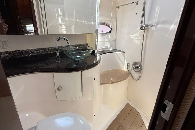  Yacht Photos Pics Luxurious bathroom in 2015 Regal 46 Sport Coupe yacht with modern fixtures and glass sink.