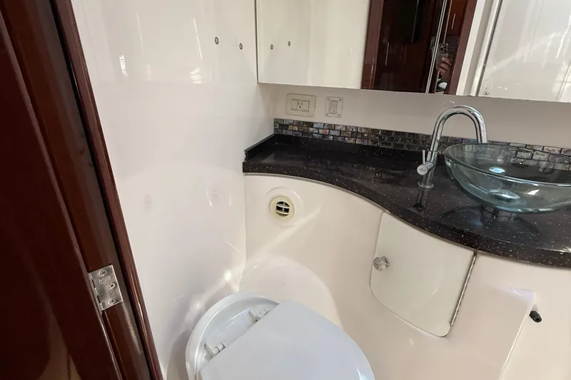  Yacht Photos Pics Luxurious bathroom in 2015 Regal 46 Sport Coupe yacht with modern fixtures and glass sink.