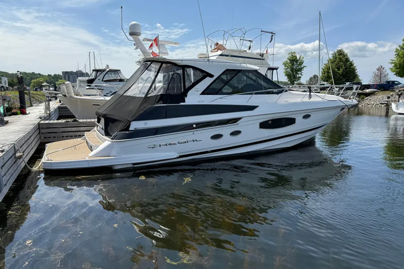  Yacht Photos Pics 2015 Regal 46 Sport Coupe yacht docked at marina on a sunny day.