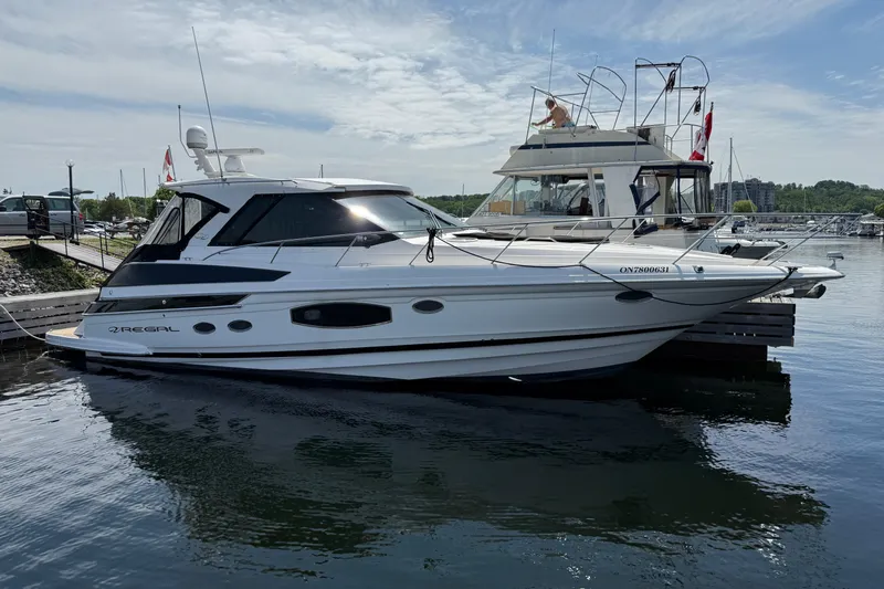  Yacht Photos Pics 2015 Regal 46 Sport Coupe yacht docked at marina under clear sky.