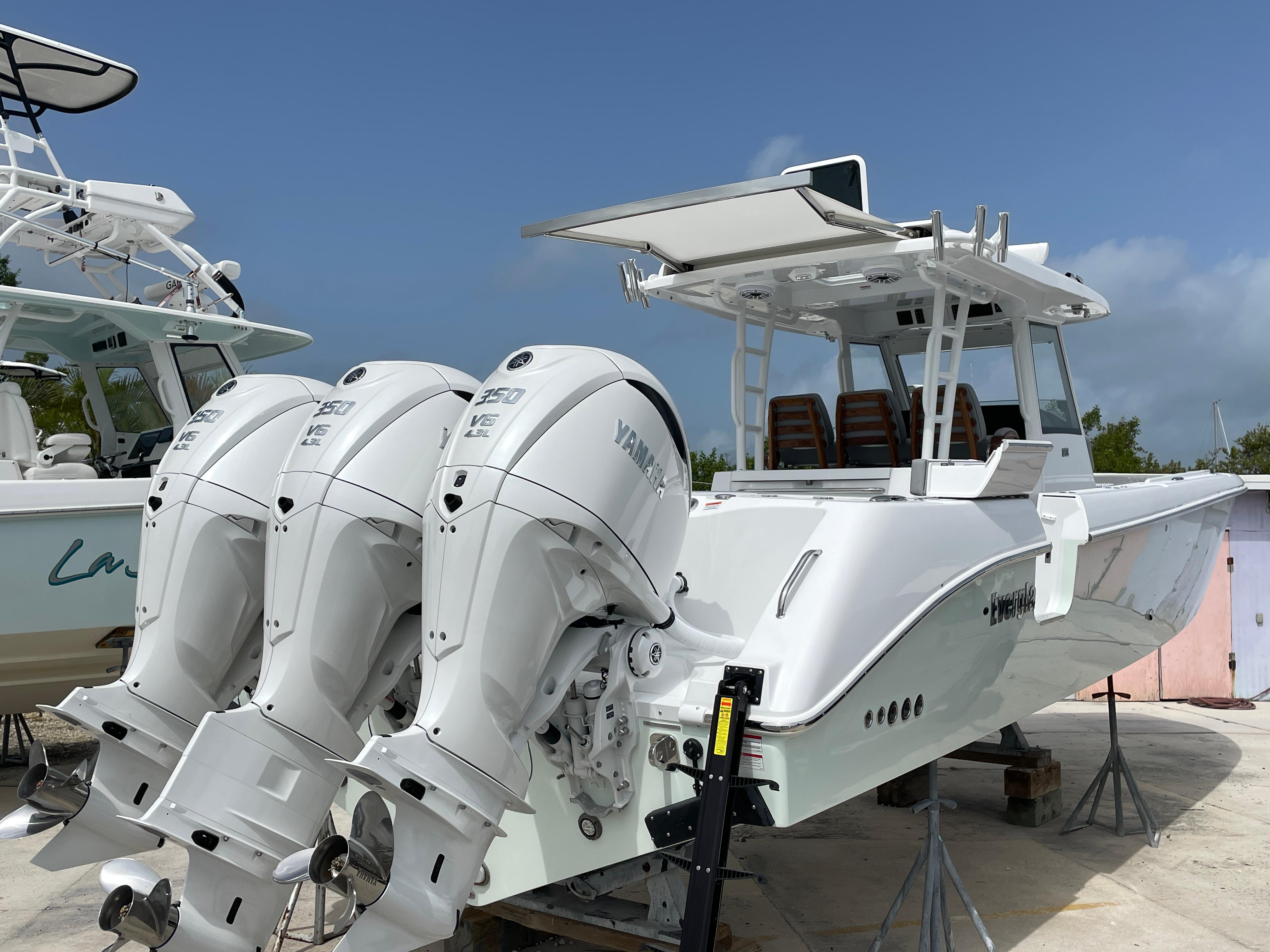 2026 Everglades 375cc boat with triple Yamaha outboard engines, docked on a sunny day.