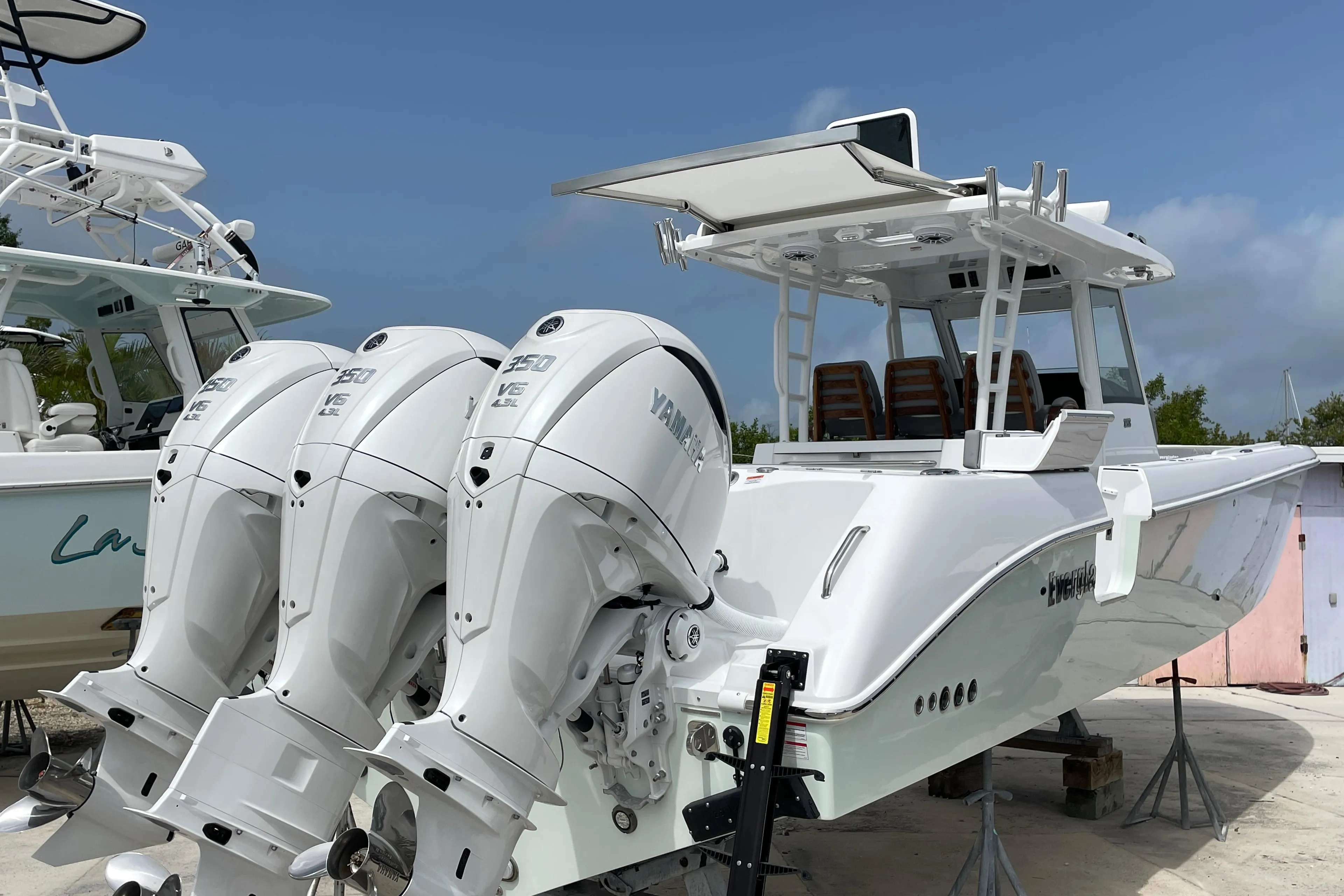 2026 Everglades 375cc boat with triple Yamaha outboard engines, docked on a sunny day.