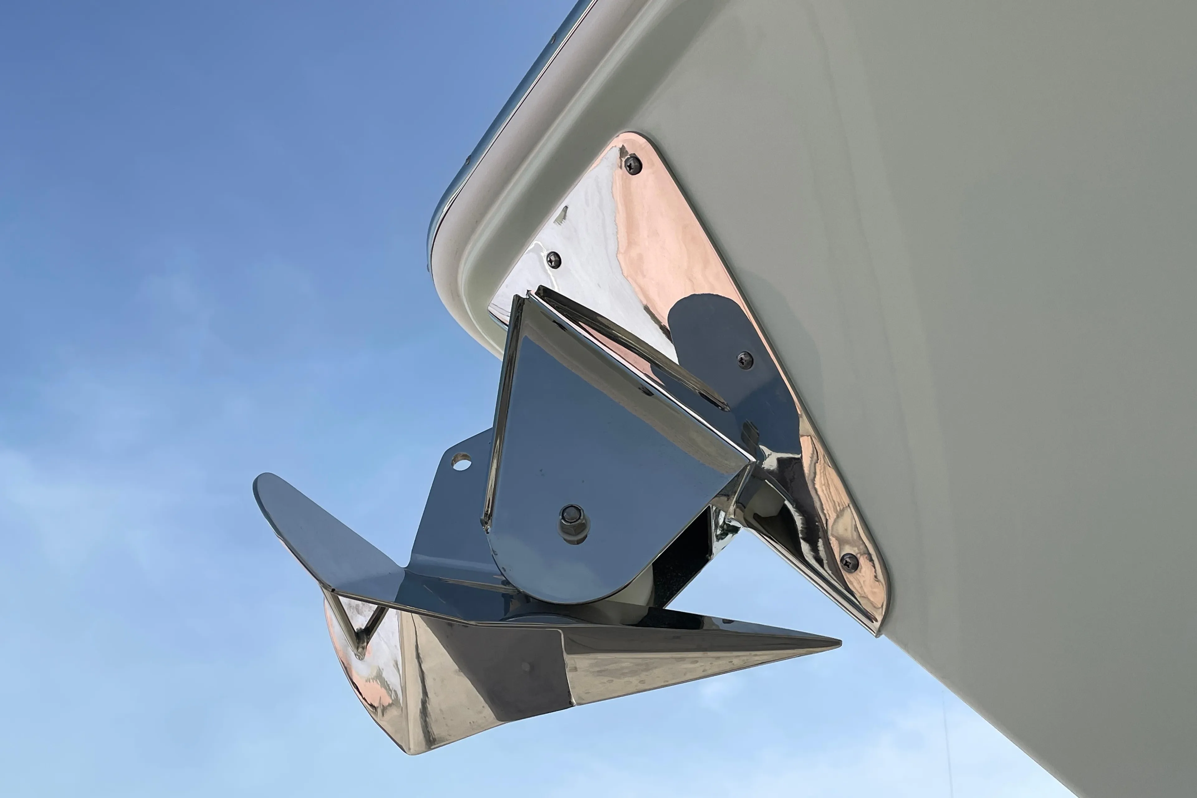 Shiny anchor on Everglades 375cc boat, 2026 model, against clear blue sky.