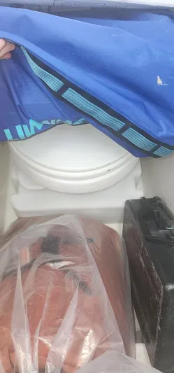  Yacht Photos Pics Boat storage area with covered toilet and equipment on a 2013 SeaVee 32.