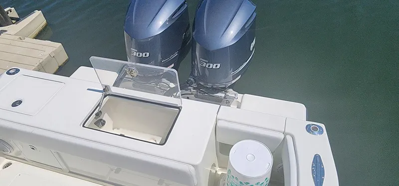  Yacht Photos Pics 2013 SeaVee 32 boat with dual 300 horsepower engines, docked on calm water.