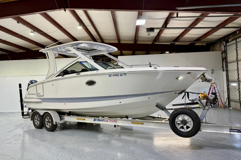  Yacht Photos Pics 2021 Chaparral 280 OSX boat on trailer in indoor storage facility.
