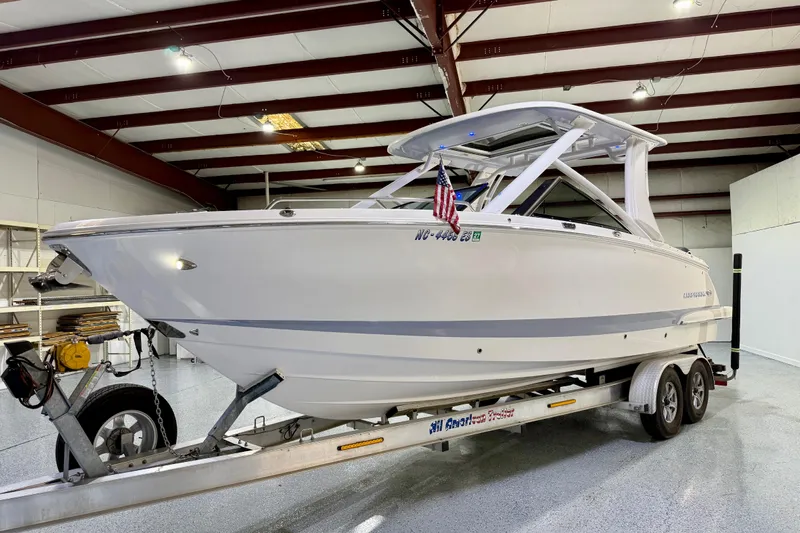  Yacht Photos Pics 2021 Chaparral 280 OSX boat on trailer in indoor storage facility.