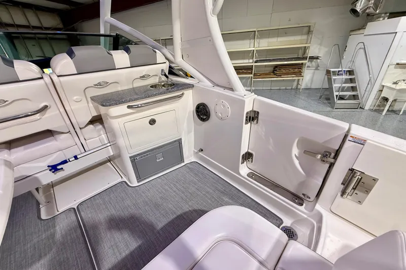  Yacht Photos Pics 2021 Chaparral 280 OSX boat interior with seating, sink, and storage compartments.