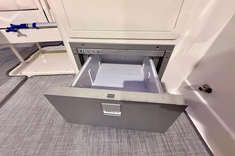  Yacht Photos Pics Open storage drawer on 2021 Chaparral 280 OSX boat, showcasing interior space.