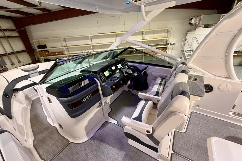  Yacht Photos Pics 2021 Chaparral 280 OSX boat interior with modern helm and seating in a showroom.