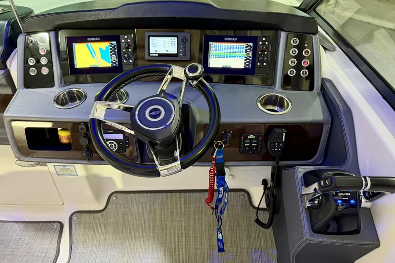  Yacht Photos Pics 2021 Chaparral 280 OSX boat dashboard with steering wheel and navigation displays.