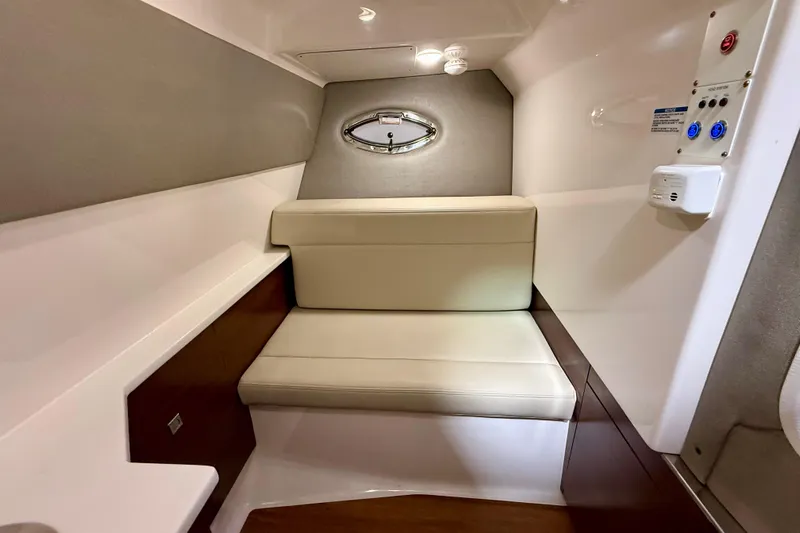  Yacht Photos Pics 2021 Chaparral 280 OSX cabin interior with beige seating and modern design.