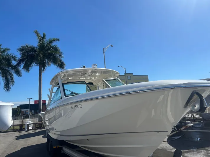 320 Vantage Yacht Photos Pics 2022 Boston Whaler 320 Vantage boat outdoors under sunny skies.