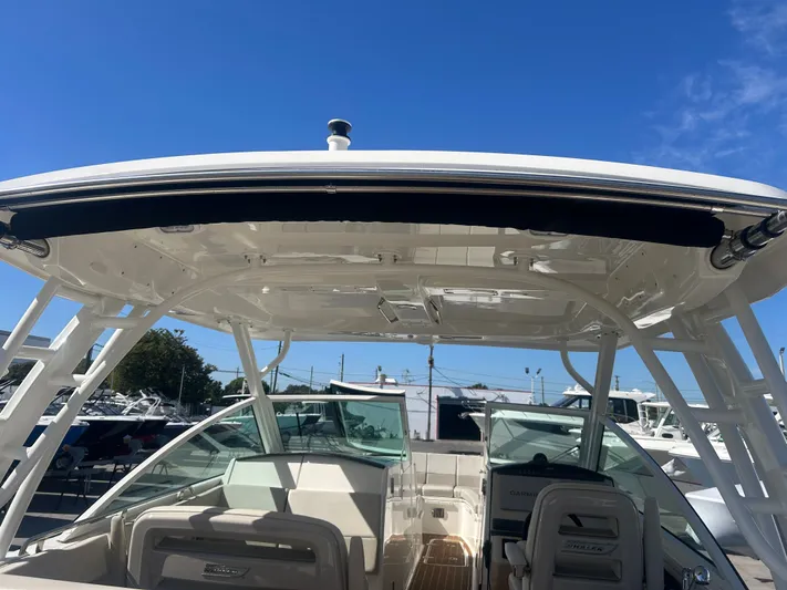 320 Vantage Yacht Photos Pics Boston Whaler 320 Vantage 2022 with open canopy and blue sky.