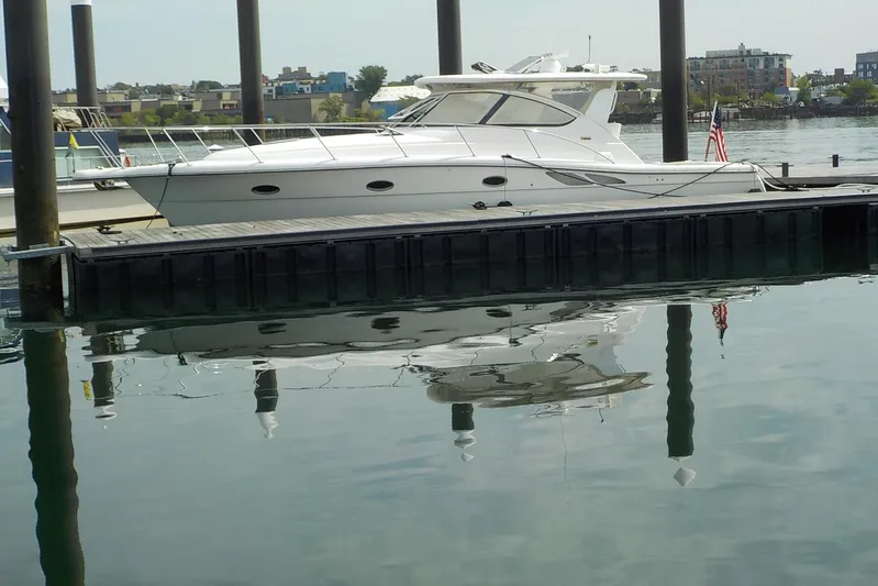 "sapphire" Yacht Photos Pics 2001 Tiara Yachts 3800 Open docked at marina, reflecting on calm water.