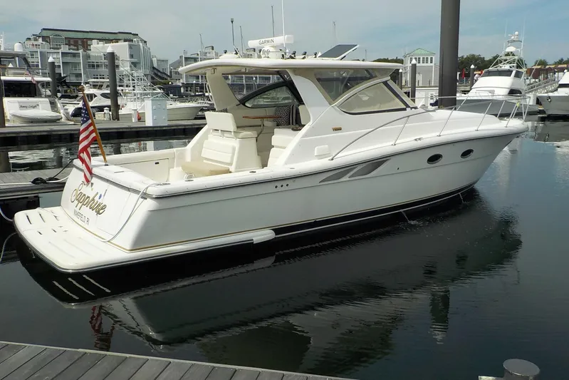 "sapphire" Yacht Photos Pics 2001 Tiara Yachts 3800 Open docked at marina, featuring sleek design and American flag.