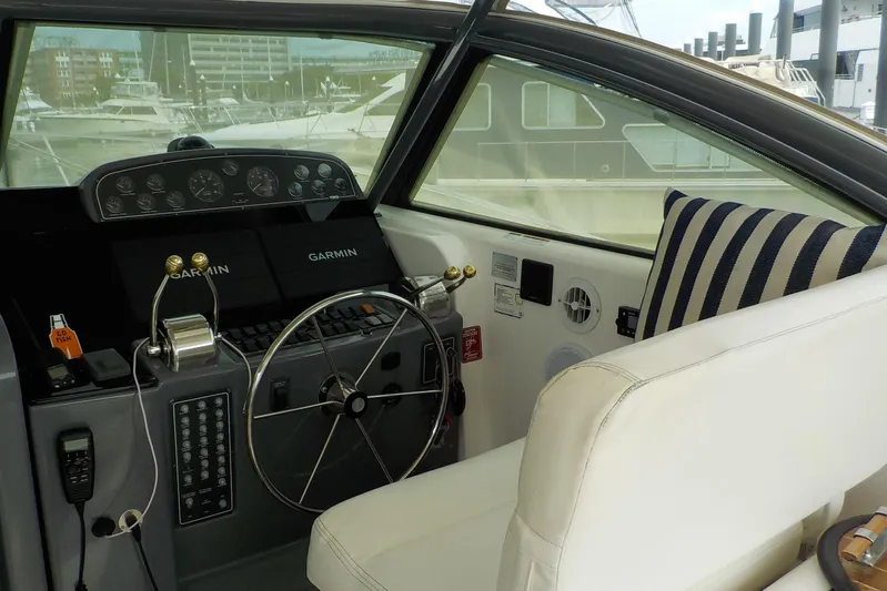 "sapphire" Yacht Photos Pics Helm of 2001 Tiara Yachts 3800 Open with Garmin navigation, striped cushion, and steering wheel.