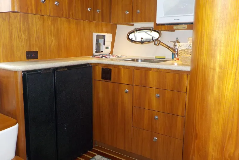 "sapphire" Yacht Photos Pics 2001 Tiara Yachts 3800 Open kitchen with wood cabinets, sink, and appliances.