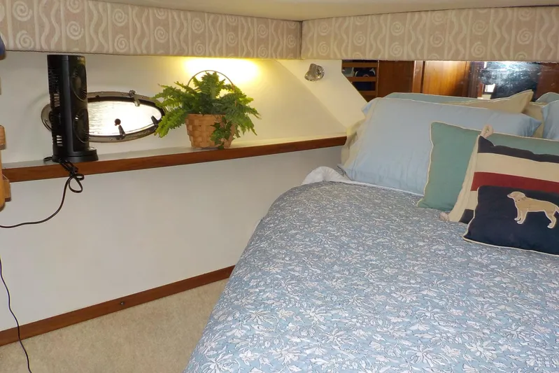 "sapphire" Yacht Photos Pics Cozy cabin interior of 2001 Tiara Yachts 3800 Open with bed and decorative pillows.