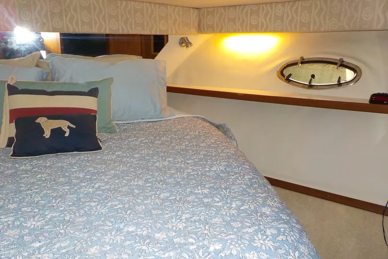 "sapphire" Yacht Photos Pics Cozy cabin interior of 2001 Tiara Yachts 3800 Open with floral bedding and decorative pillows.