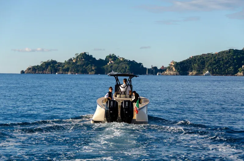  Yacht Photos Pics AlCustom Levanzo 25 boat cruising on open sea, 2025 model, with scenic island backdrop.