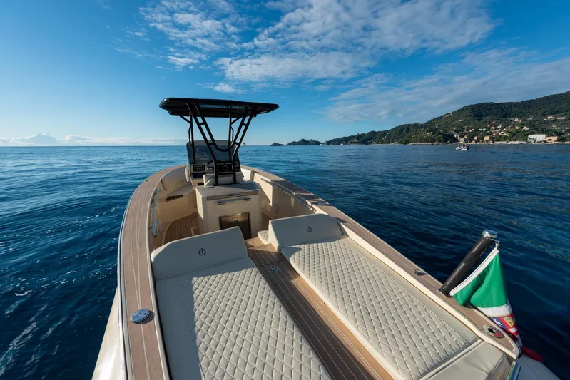  Yacht Photos Pics AlCustom Levanzo 25 boat cruising on calm sea, 2025 model, with scenic coastal backdrop.