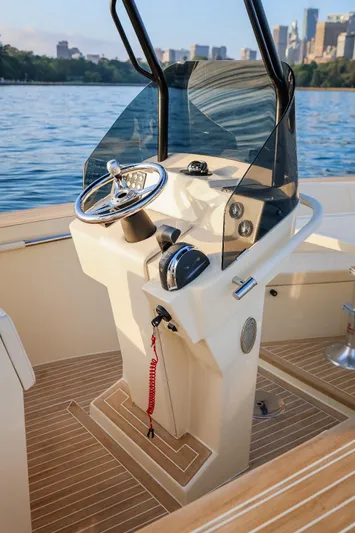  Yacht Photos Pics 2025 AlCustom Levanzo 25 boat helm with steering wheel and controls, on calm water.