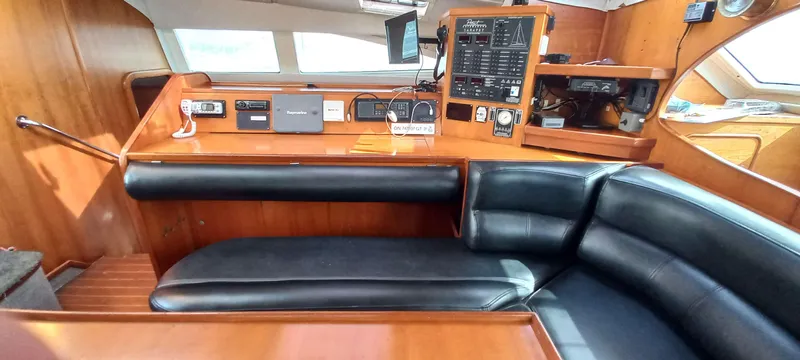 Zarafet Yacht Photos Pics Interior of 1995 Prout 45 yacht with navigation equipment and leather seating.