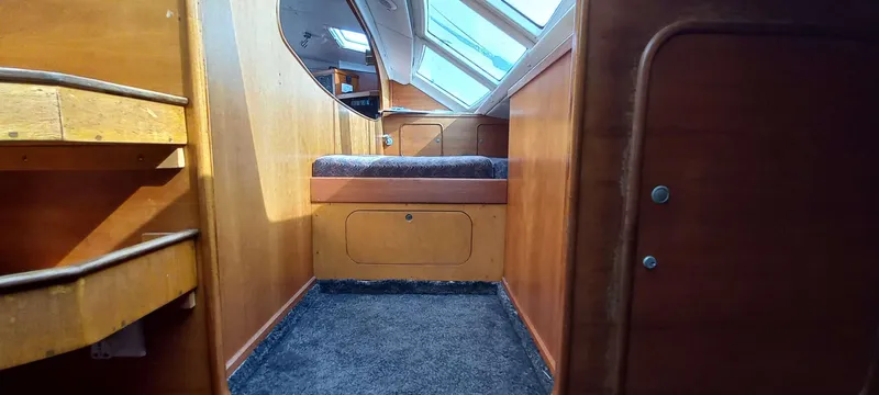 Zarafet Yacht Photos Pics Interior of a 1995 Prout 45 yacht, featuring wooden paneling and carpeted flooring.