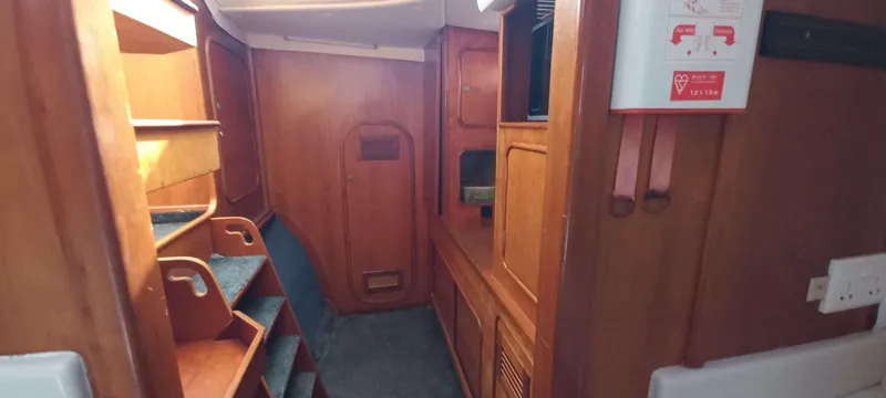 Zarafet Yacht Photos Pics Interior of 1995 Prout 45 yacht with wooden cabinetry and shelving.