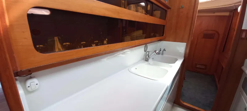 Zarafet Yacht Photos Pics Interior of 1995 Prout 45 yacht featuring a sleek kitchen counter and dual sinks.