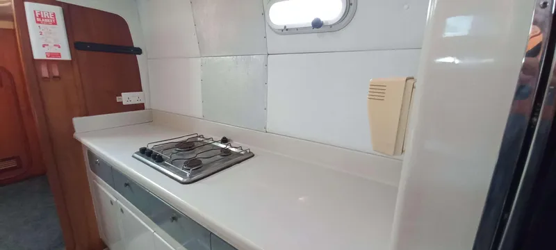 Zarafet Yacht Photos Pics Galley kitchen in 1995 Prout 45 yacht with stove and window.