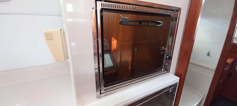 Zarafet Yacht Photos Pics 1995 Prout 45 yacht interior with built-in wooden cabinet and modern appliances.