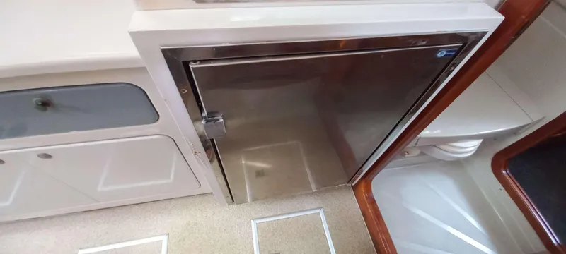 Zarafet Yacht Photos Pics Interior of 1995 Prout 45 yacht showing stainless steel fridge and cabinetry.