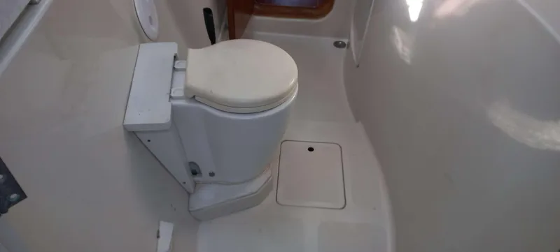 Zarafet Yacht Photos Pics Interior of a 1995 Prout 45 boat bathroom with a compact toilet.