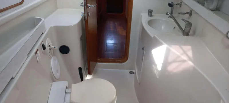 Zarafet Yacht Photos Pics Bathroom interior of a 1995 Prout 45 yacht, featuring a toilet and sink.