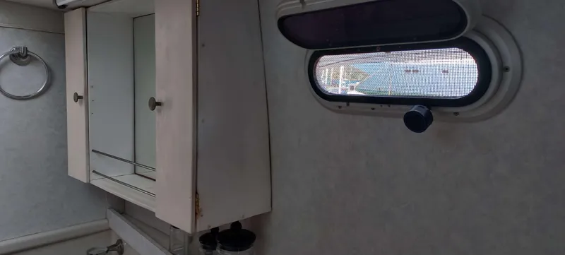 Zarafet Yacht Photos Pics Interior of 1995 Prout 45 boat with cabinet and porthole window.