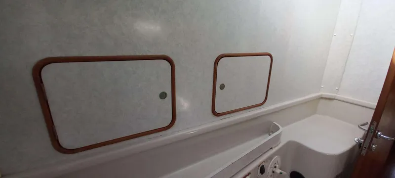 Zarafet Yacht Photos Pics Interior of a 1995 Prout 45 yacht bathroom with storage compartments.