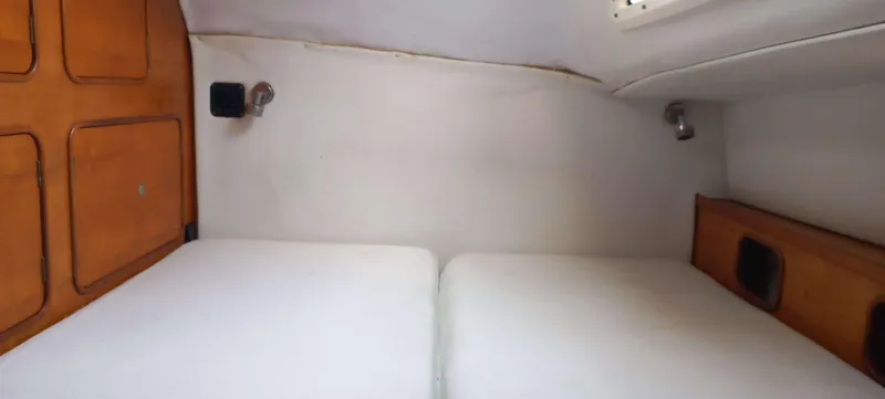 Zarafet Yacht Photos Pics Interior cabin of 1995 Prout 45 catamaran with twin beds and wooden accents.