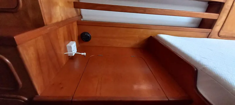 Zarafet Yacht Photos Pics Interior cabin of 1995 Prout 45 yacht with wooden finish and bed.