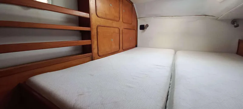 Zarafet Yacht Photos Pics Interior cabin of 1995 Prout 45 catamaran with wooden storage and twin beds.