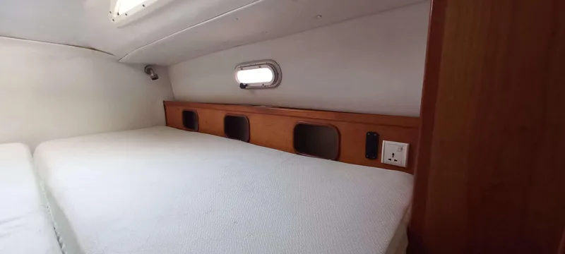 Zarafet Yacht Photos Pics Cozy cabin interior of 1995 Prout 45 yacht with bed and wooden storage.