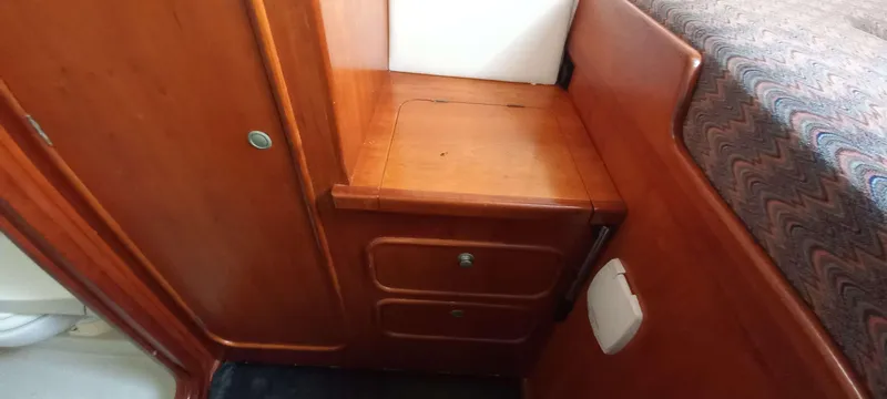 Zarafet Yacht Photos Pics Interior of 1995 Prout 45 yacht with wooden cabinetry and bed.