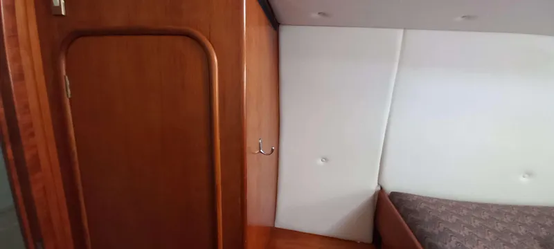 Zarafet Yacht Photos Pics Interior cabin of a 1995 Prout 45 yacht with wooden door and bed.