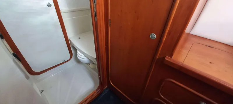 Zarafet Yacht Photos Pics Interior of 1995 Prout 45 yacht showing bathroom with wooden cabinetry and shower.