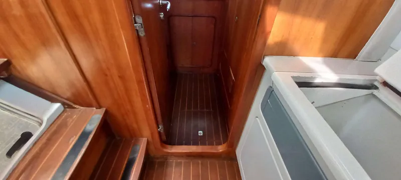 Zarafet Yacht Photos Pics Interior of 1995 Prout 45 yacht with wooden paneling and compact kitchen area.