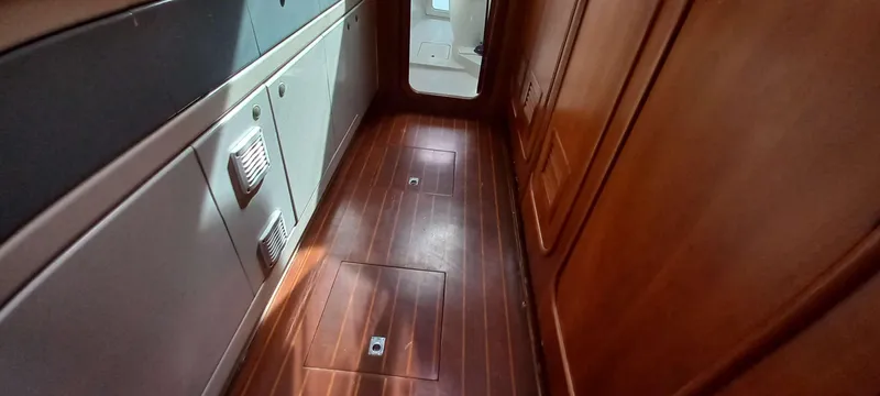 Zarafet Yacht Photos Pics Interior view of a 1995 Prout 45 yacht with wooden flooring and cabinetry.