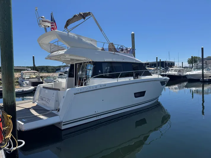 Portkey Yacht Photos Pics 2016 Jeanneau Velasco 37F yacht docked in a marina under clear blue skies.